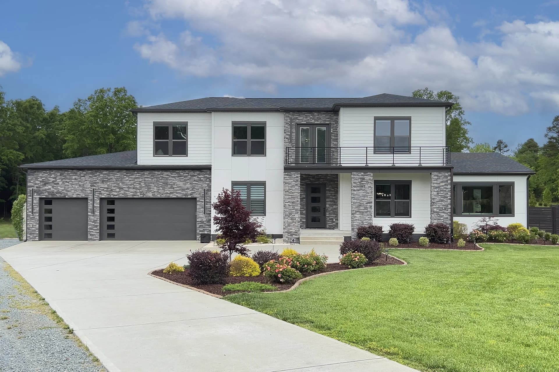 Two-story white and charcoal home with a broad lawn on West Duncan Road